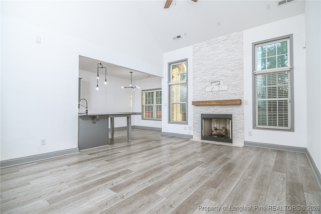 808 Mumford Road Raeford, NC 28376 - Photo 5 of 50 a view of an empty room with wooden floor fireplace and a window