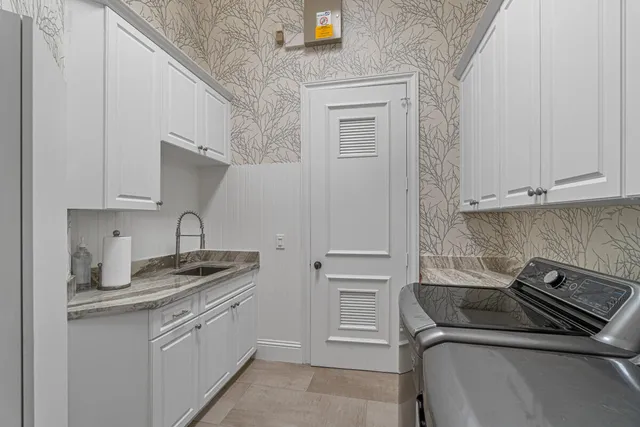 a kitchen with white cabinets and white appliances