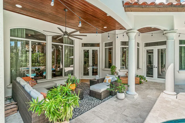 a building outdoor space with patio furniture and potted plants