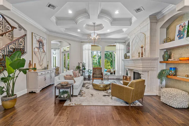 a living room with fireplace furniture and a large window