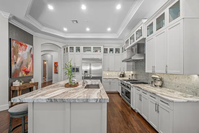 a kitchen with stainless steel appliances granite countertop a sink and cabinets