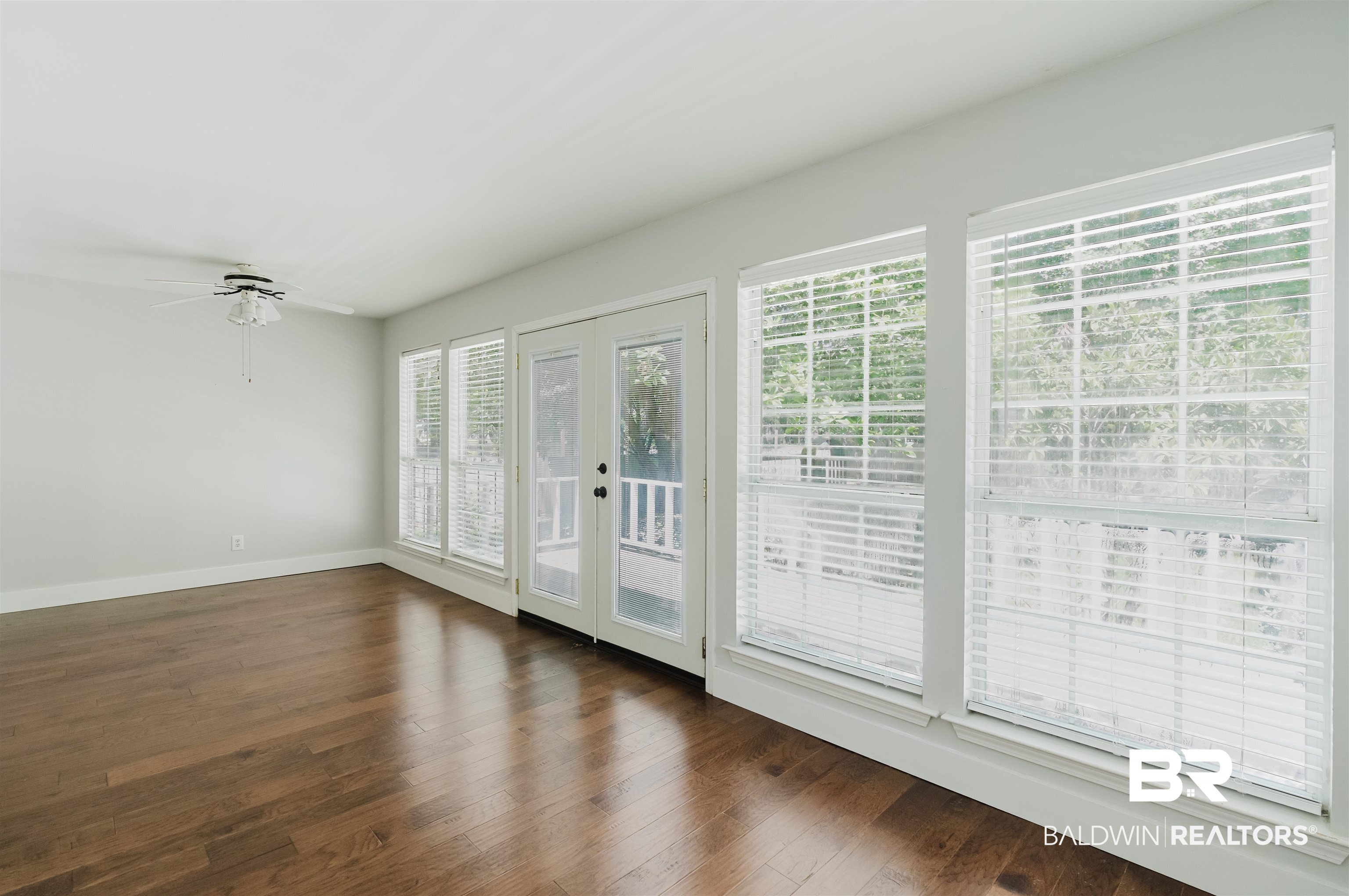 20460 Bishop Road Fairhope, AL 36532 - Photo 20 of 41 Spare room with plenty of natural light, dark wood finished floors, and baseboards