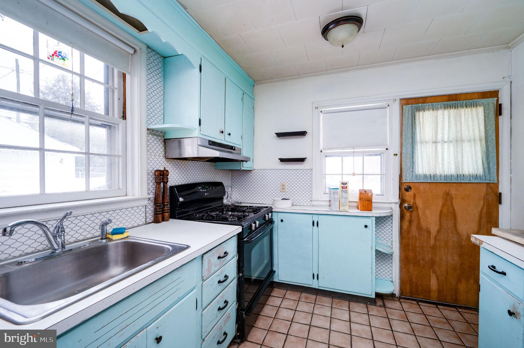 9 West 35th Street Reading, PA 19606 - Photo 22 of 52 a kitchen with a sink stove and cabinets
