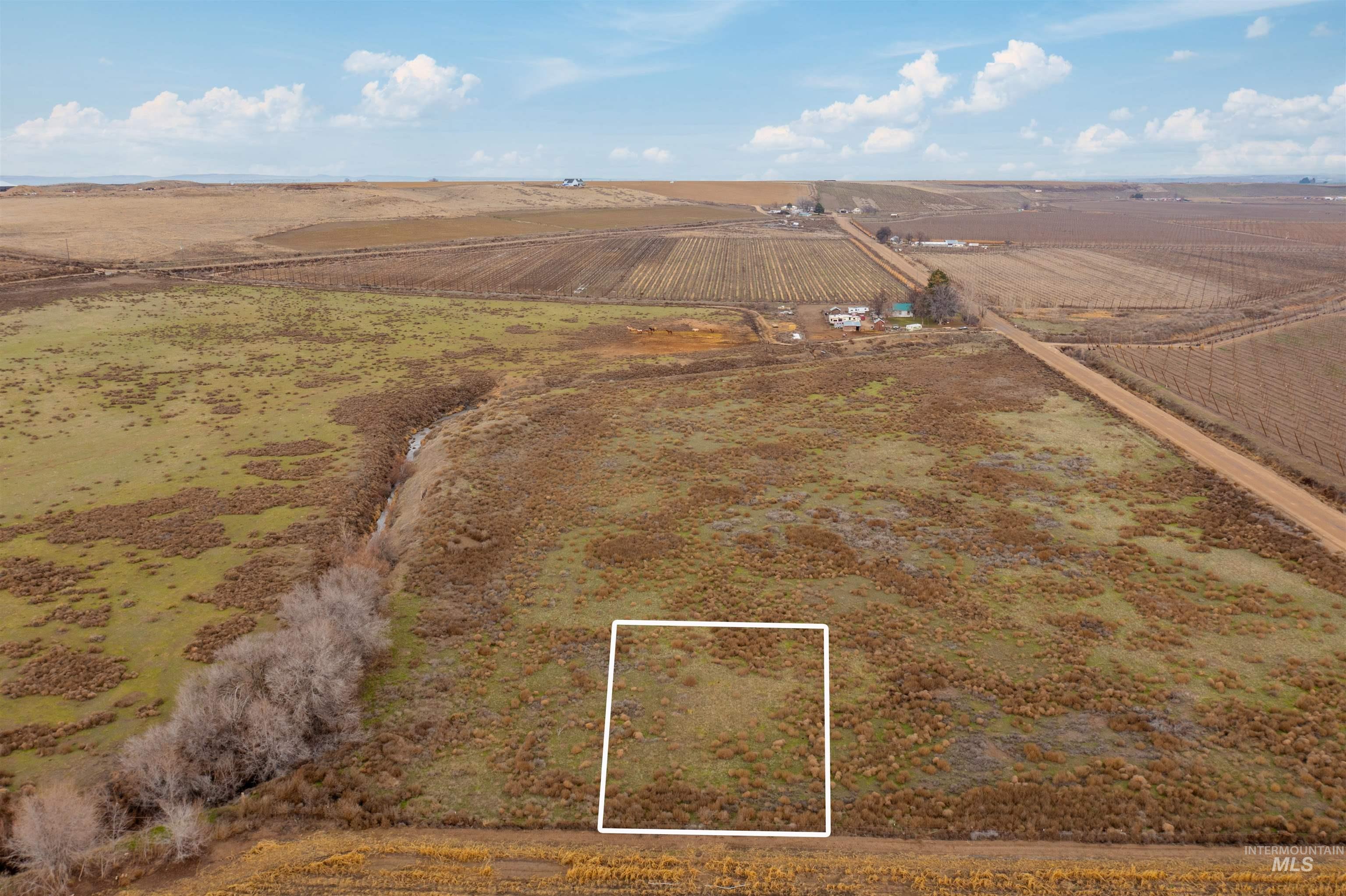 Aerial view of sparsely populated area featuring extensive farmland and property boundaries highlighted