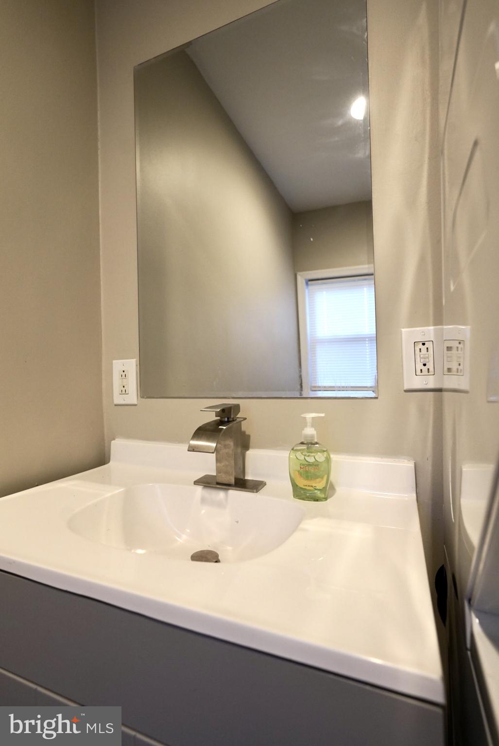 2655 Cedar Street Philadelphia, PA 19125 - Photo 16 of 19 a bathroom with a sink and a mirror