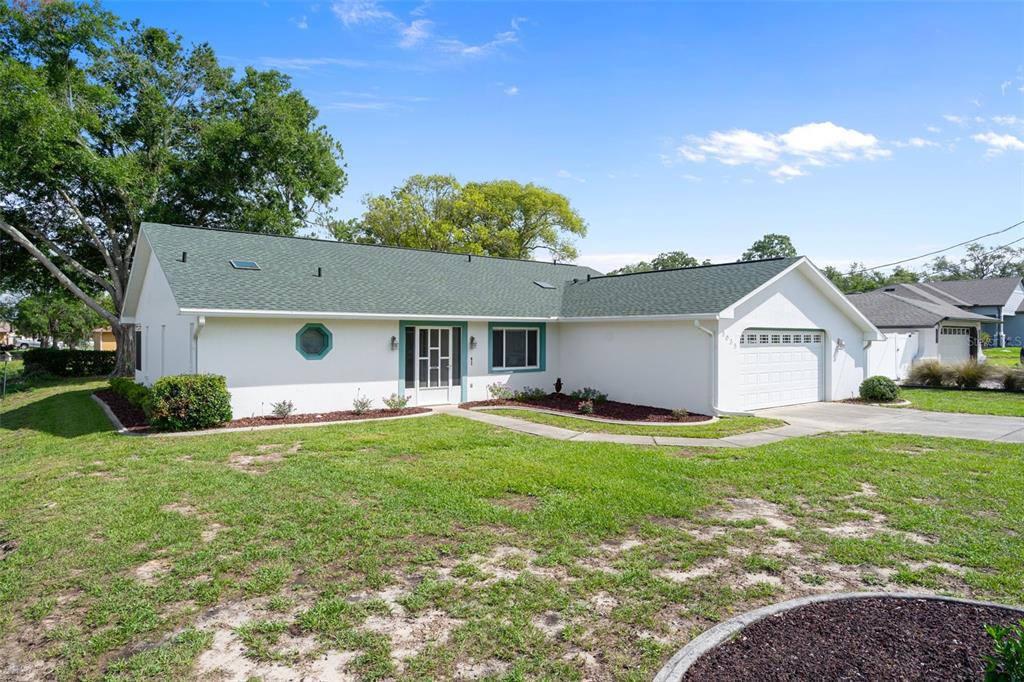 5035 Harbinger Road Spring Hill, FL 34608 - Photo 8 of 47 a view of a house with a yard