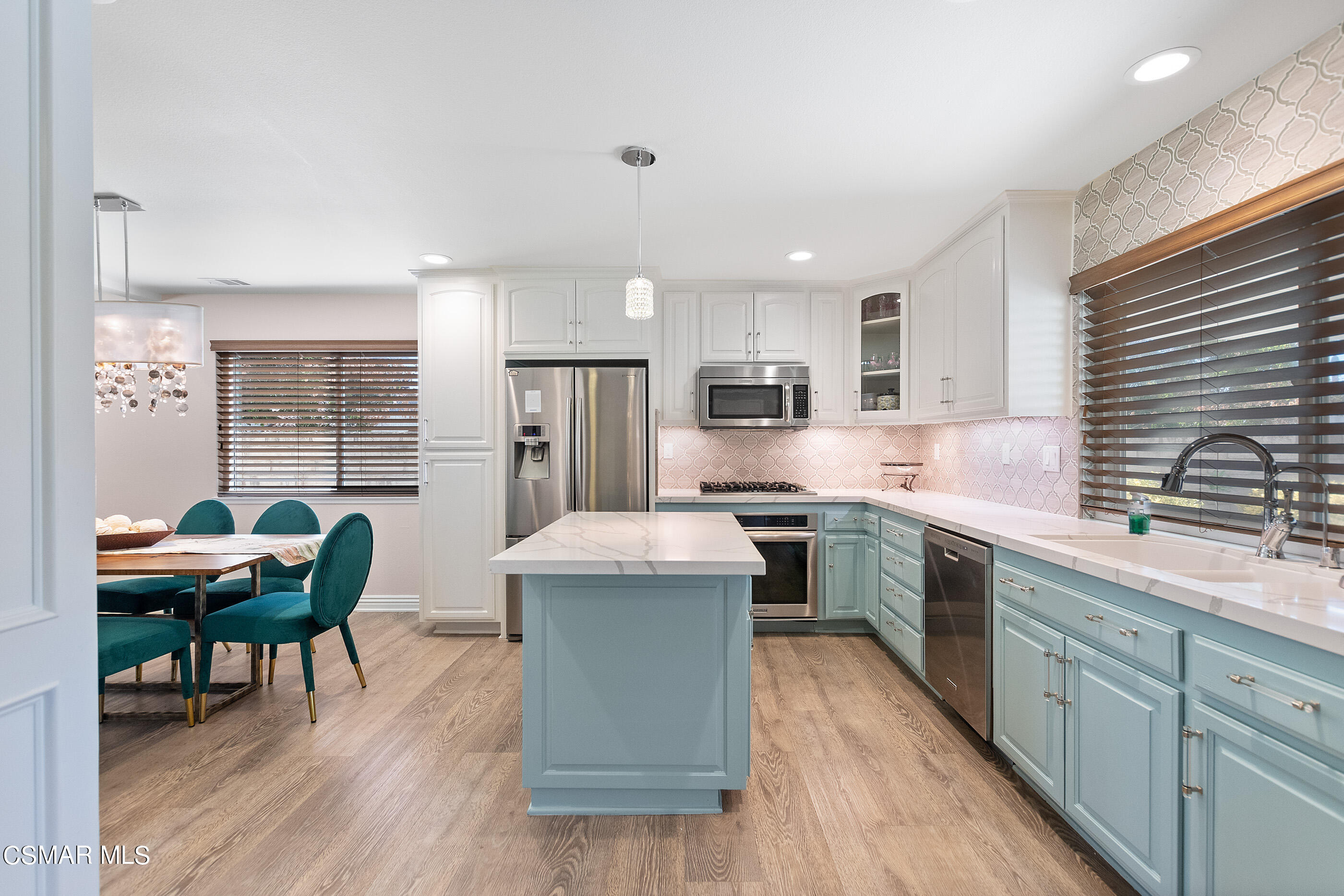 2835 Topaz Avenue Simi Valley, CA 93063 - Photo 11 of 42 a kitchen with granite countertop kitchen island stainless steel appliances a table and chairs in it