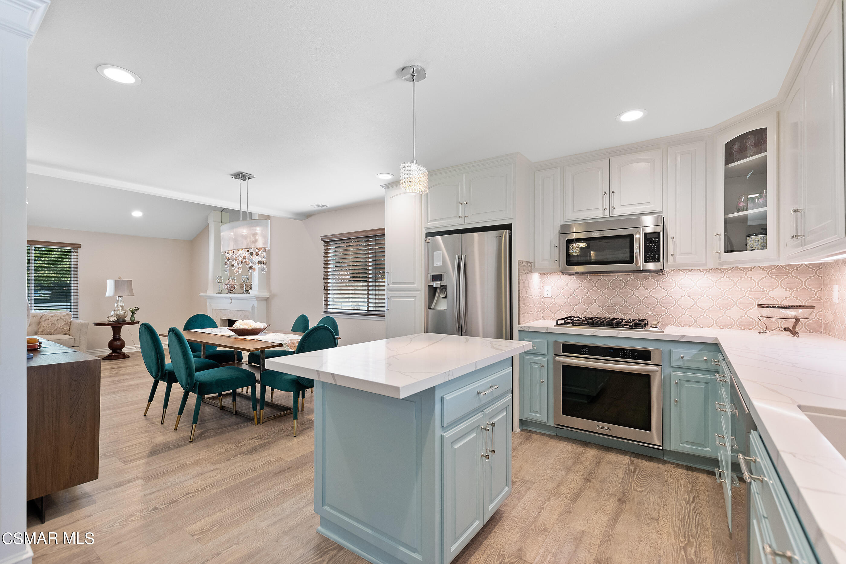 2835 Topaz Avenue Simi Valley, CA 93063 - Photo 12 of 42 a kitchen with stainless steel appliances granite countertop a stove refrigerator sink dining table and chairs