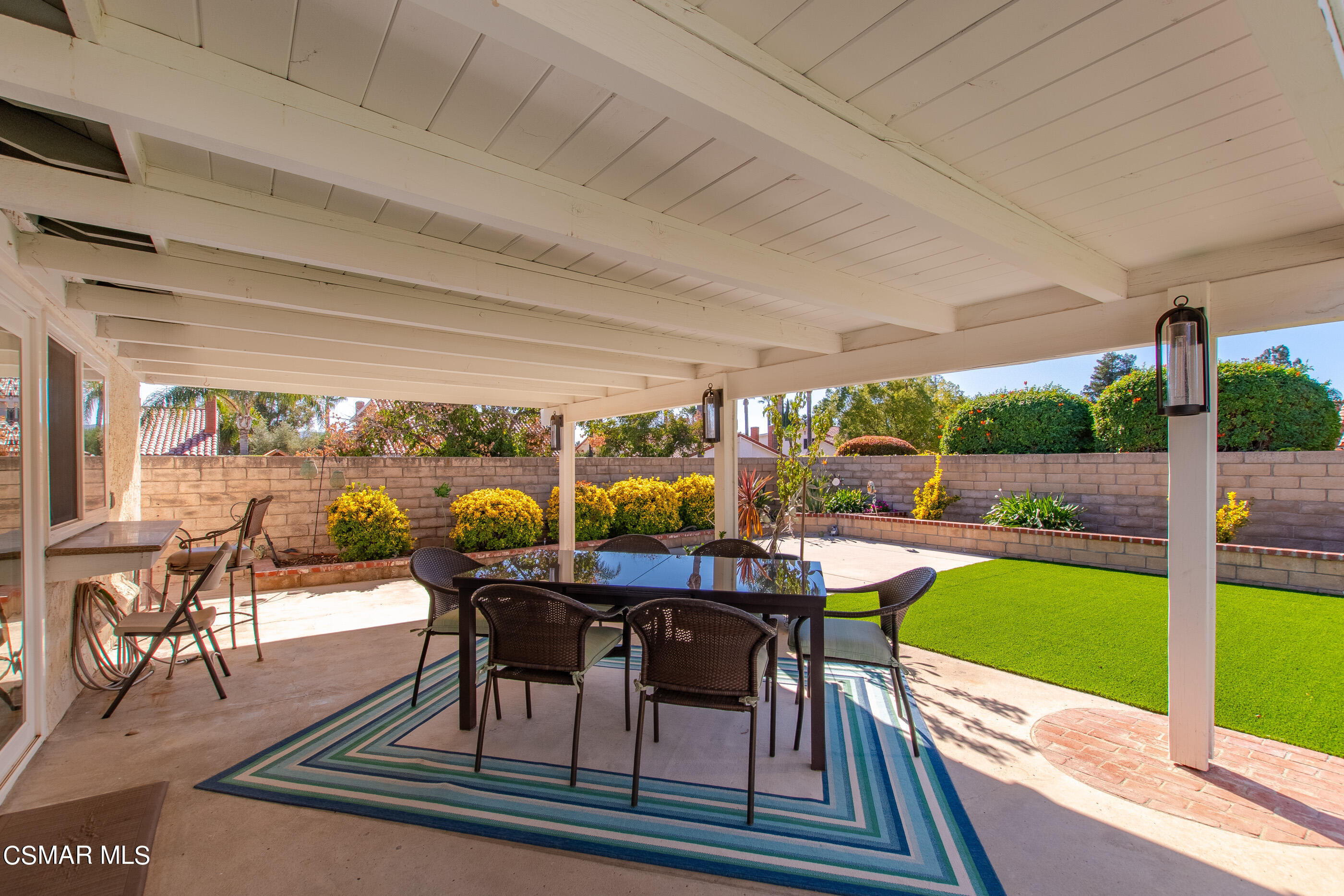2835 Topaz Avenue Simi Valley, CA 93063 - Photo 29 of 42 a view of a patio with table and chairs potted plants with floor to ceiling window