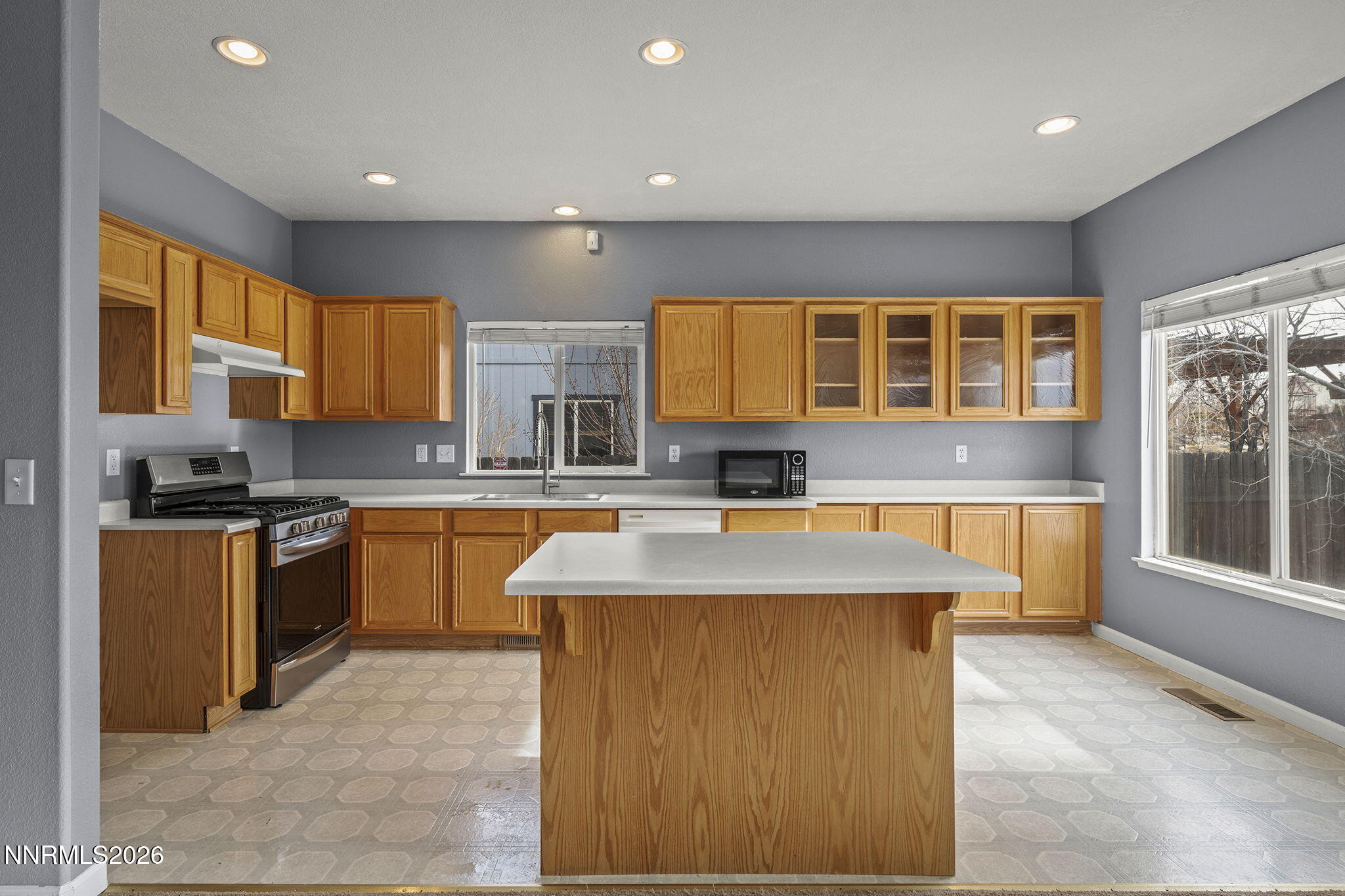 750 West Golden Valley Road Reno, NV 89506 - Photo 12 of 41 a large kitchen with stainless steel appliances granite countertop a stove a sink and a microwave