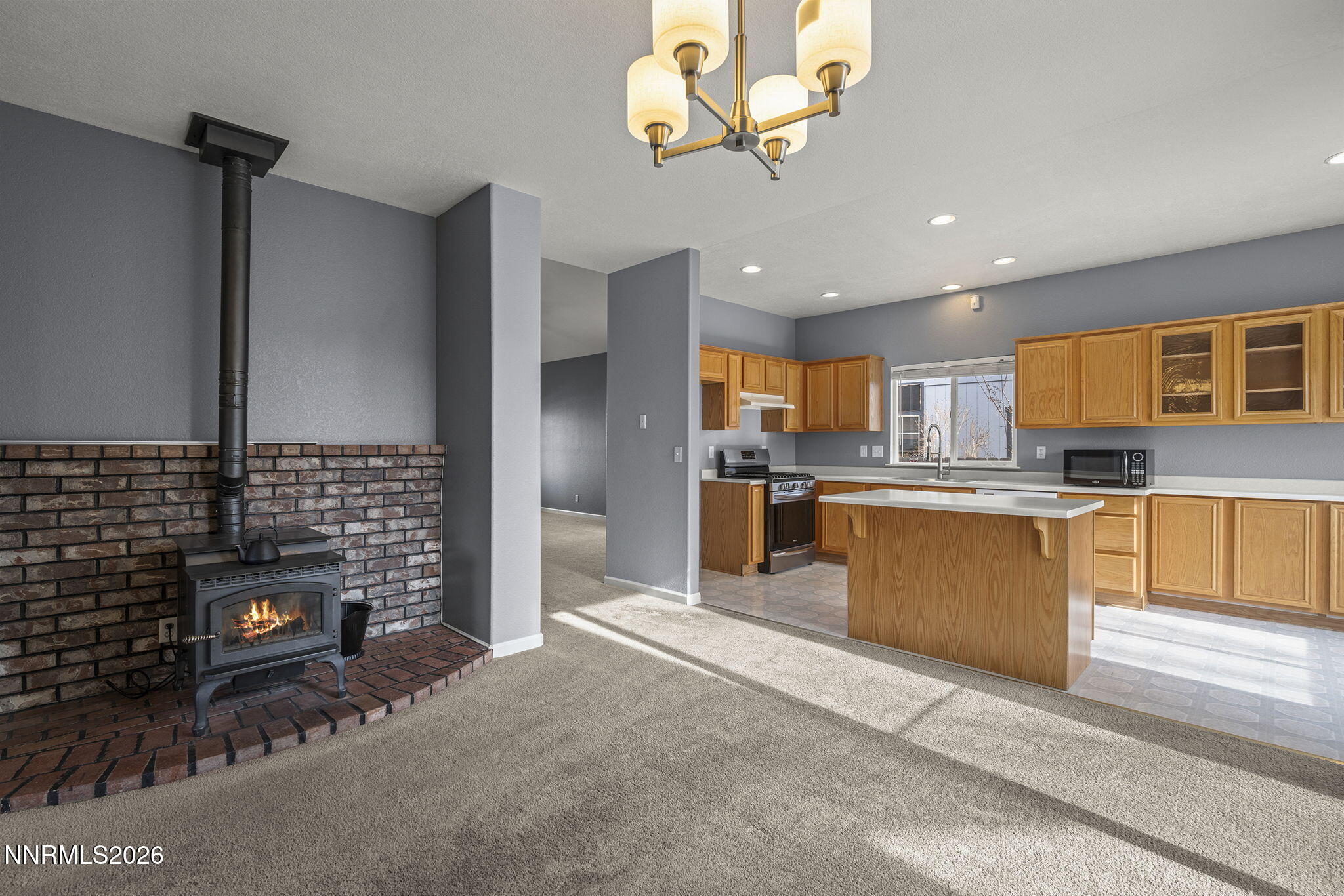 750 West Golden Valley Road Reno, NV 89506 - Photo 17 of 41 a kitchen with stainless steel appliances kitchen island granite countertop a stove top oven a sink and cabinets