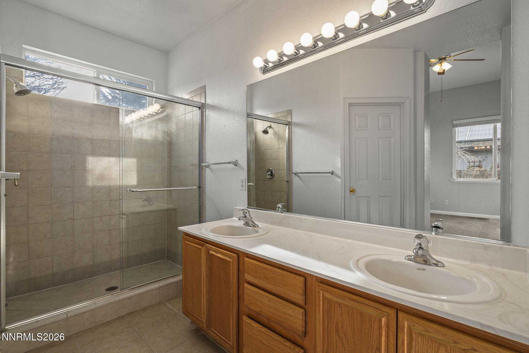 750 West Golden Valley Road Reno, NV 89506 - Photo 20 of 41 a bathroom with a shower sink and mirror