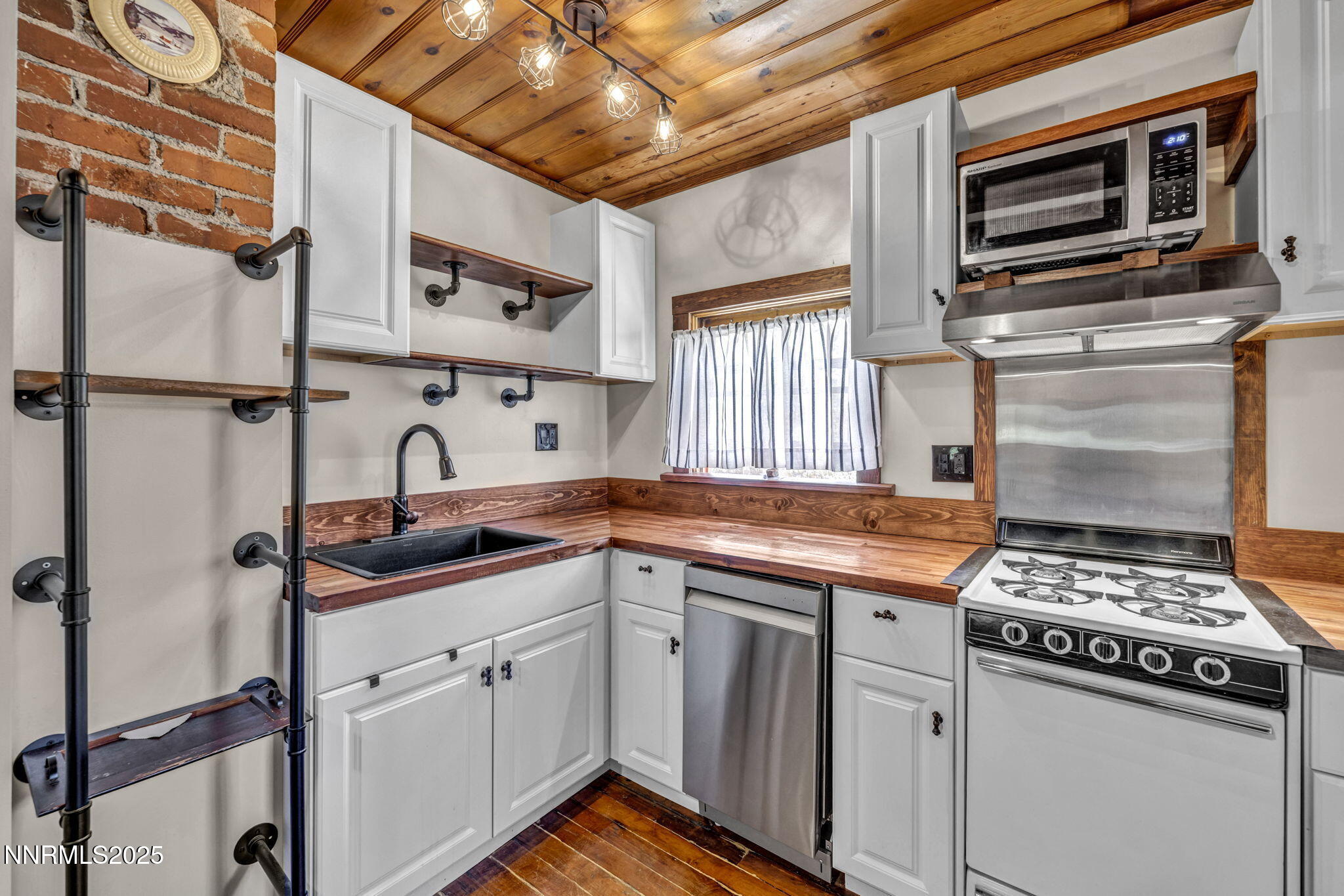 70 4th Street Silver City, NV 89428 - Photo 12 of 29 a kitchen with stainless steel appliances granite countertop a stove sink and cabinets