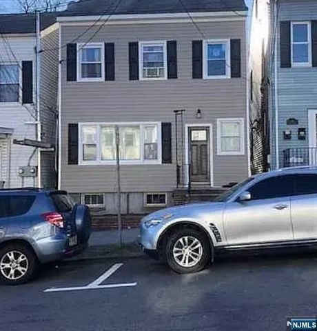a front view of a house with parking space