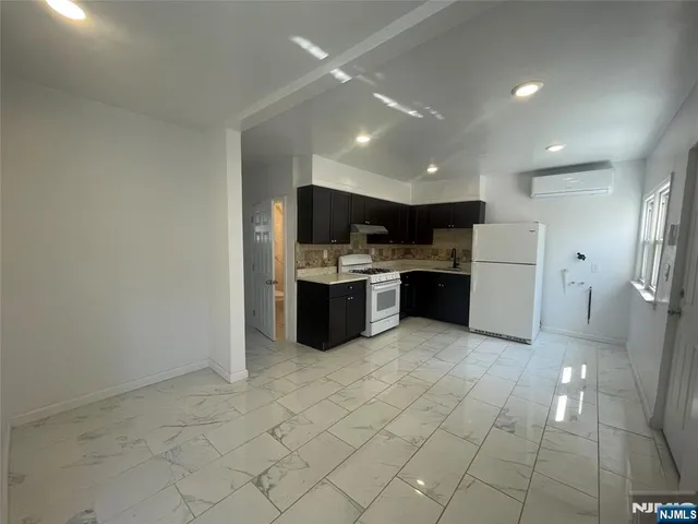 a kitchen with stainless steel appliances a refrigerator and a stove top oven