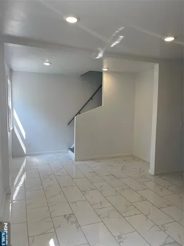 an empty room with white walls and tiles