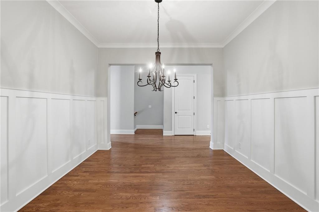 222 Trecastle Square, Unit 21 Canton, GA 30114 - Photo 6 of 33 a view of a chandelier in hallway with wooden floor