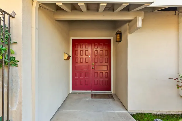 a kitchen with stainless steel appliances granite countertop a stove a sink dishwasher a dining table and chairs with wooden floor