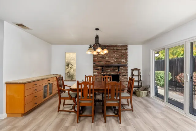 a kitchen with stainless steel appliances granite countertop a refrigerator a oven a stove and a refrigerator with wooden floor