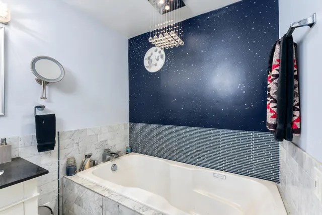 a view of backyard with wooden fence and a large tree