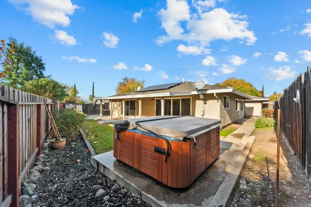 a view of a house with a yard and sitting area