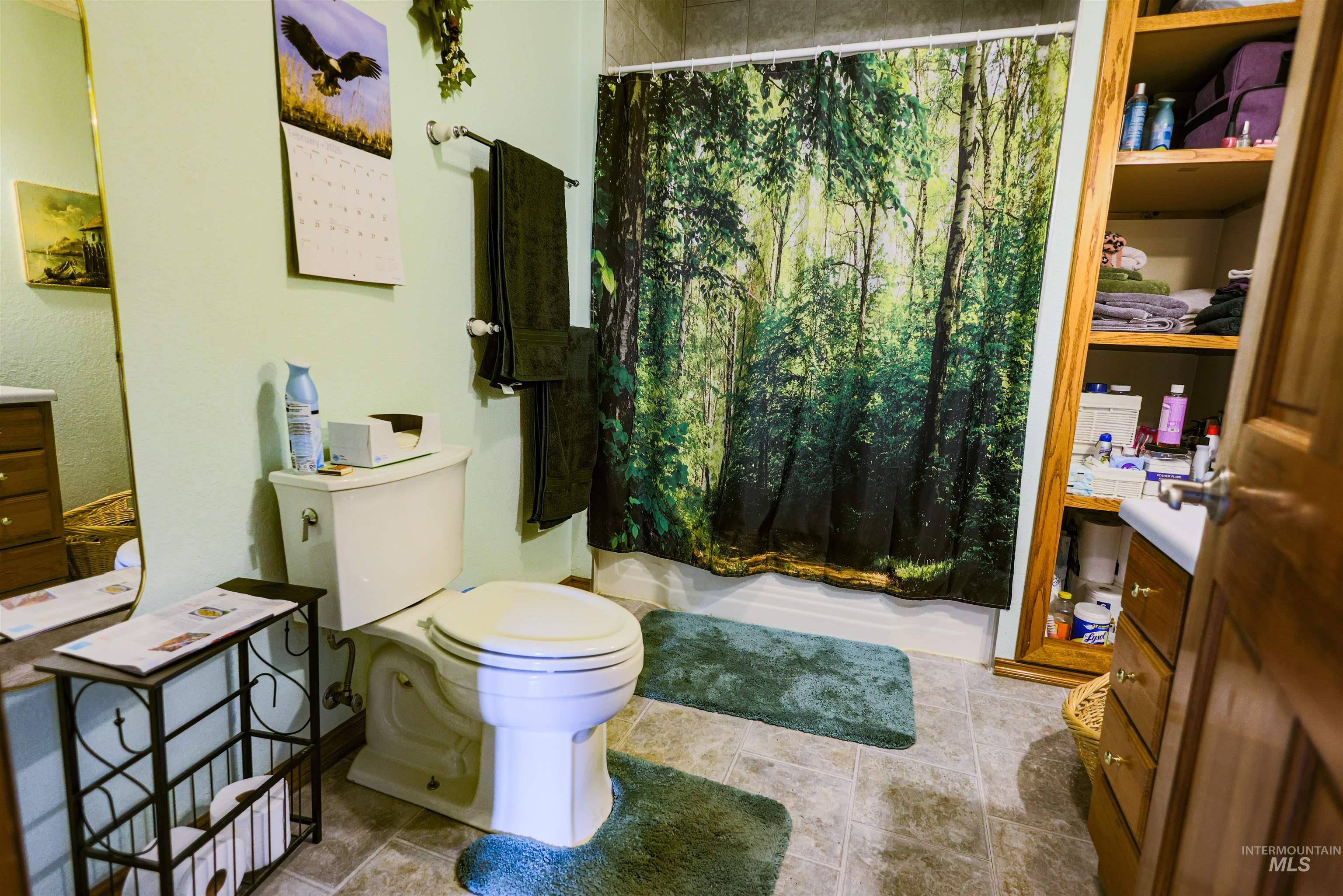 804 Maple Street Kamiah, ID 83536 - Photo 11 of 50 Full bathroom featuring toilet and shower / bathtub combination with curtain