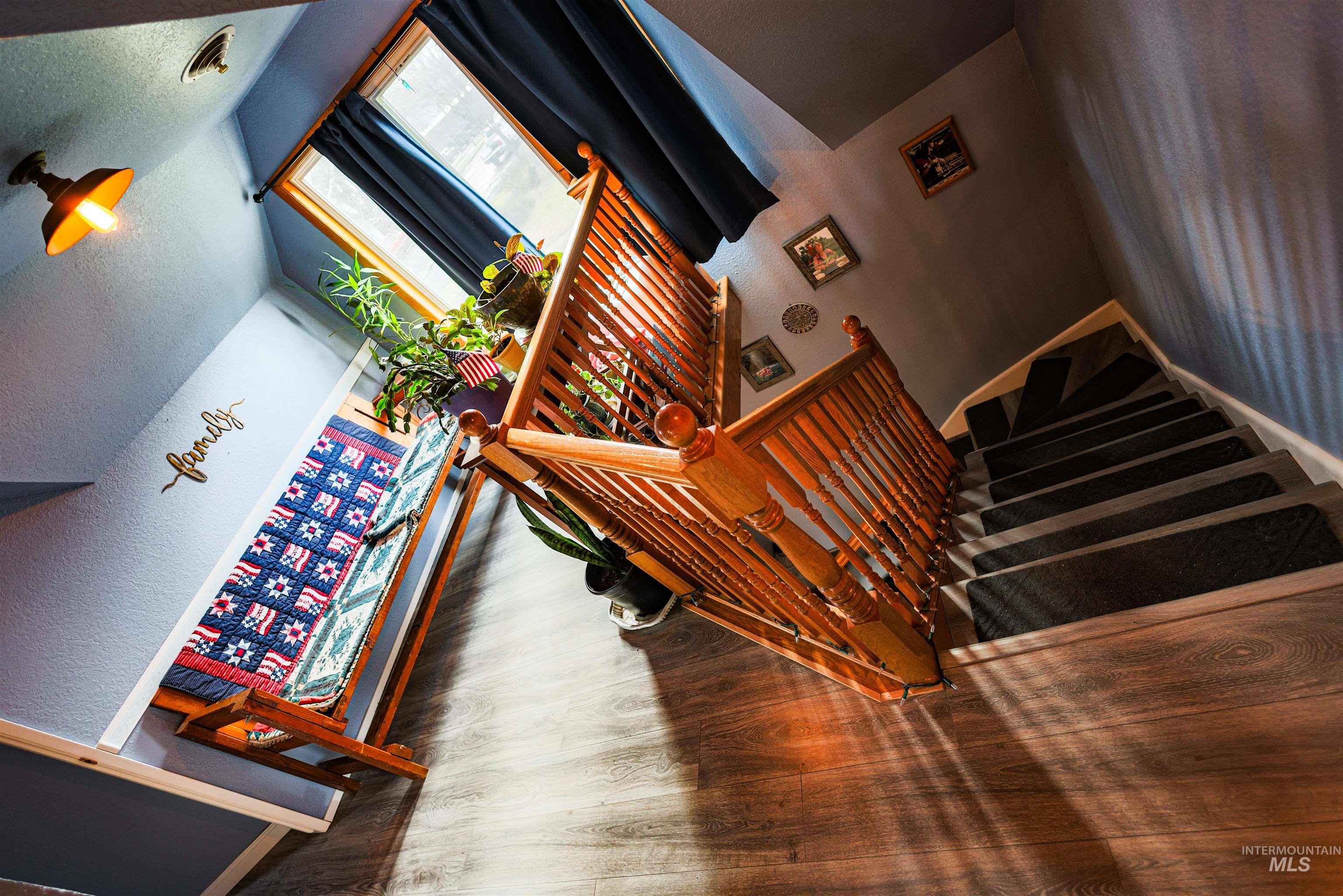 804 Maple Street Kamiah, ID 83536 - Photo 14 of 50 Stairs featuring wood finished floors and a high ceiling