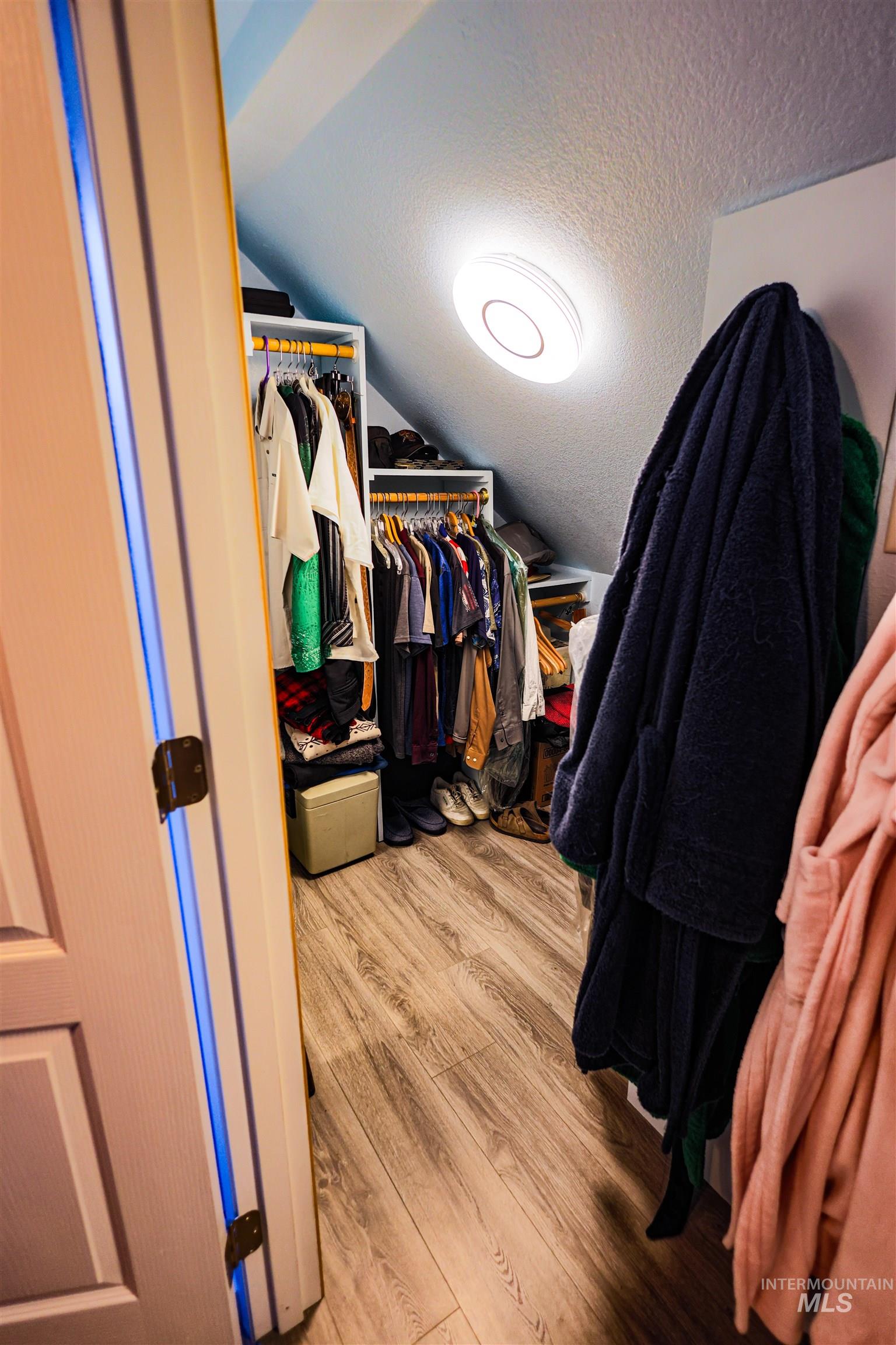 804 Maple Street Kamiah, ID 83536 - Photo 15 of 50 Walk in closet featuring light wood-style floors and vaulted ceiling
