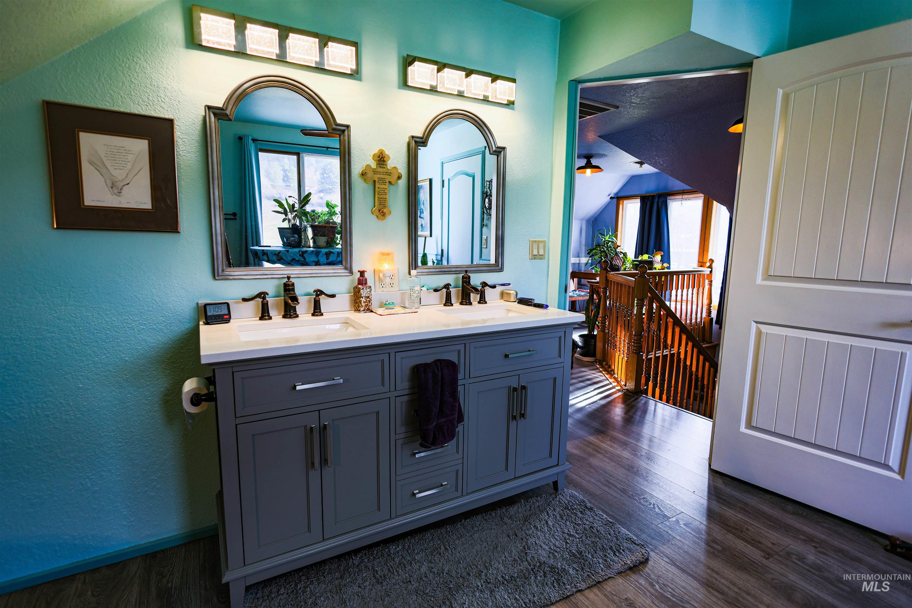 804 Maple Street Kamiah, ID 83536 - Photo 21 of 50 Full bath featuring double vanity, a textured wall, and dark wood-style floors