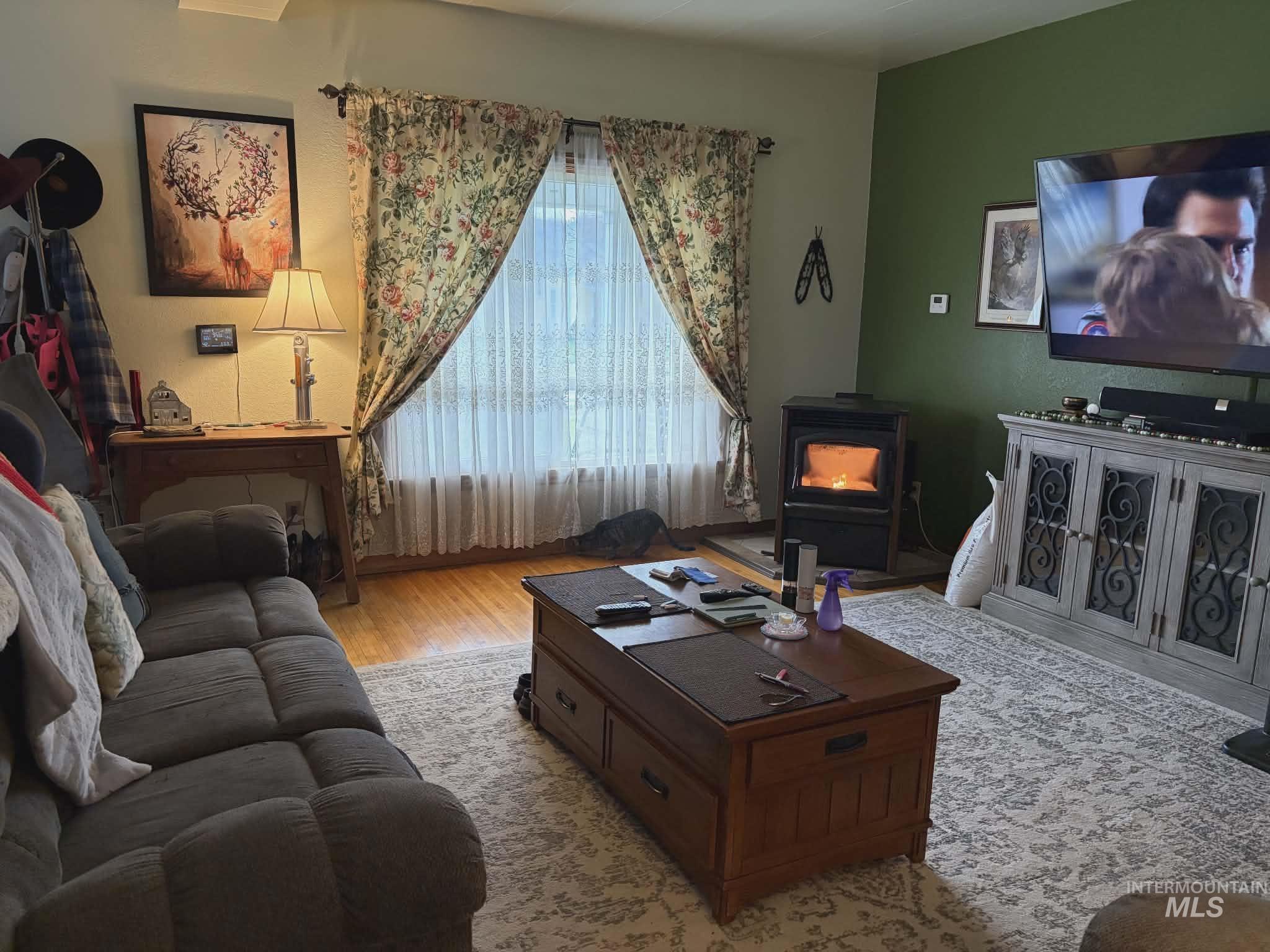 804 Maple Street Kamiah, ID 83536 - Photo 28 of 50 Living area featuring wood finished floors and a wood stove