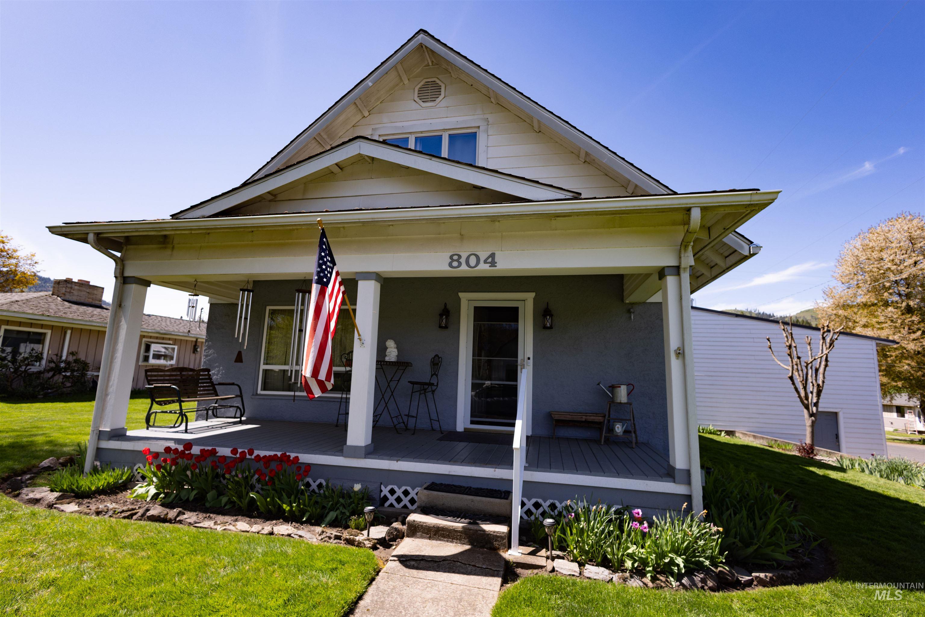 804 Maple Street Kamiah, ID 83536 - Photo 34 of 50 Charming facade with a covered front porch featuring white columns and a clear glass entry door