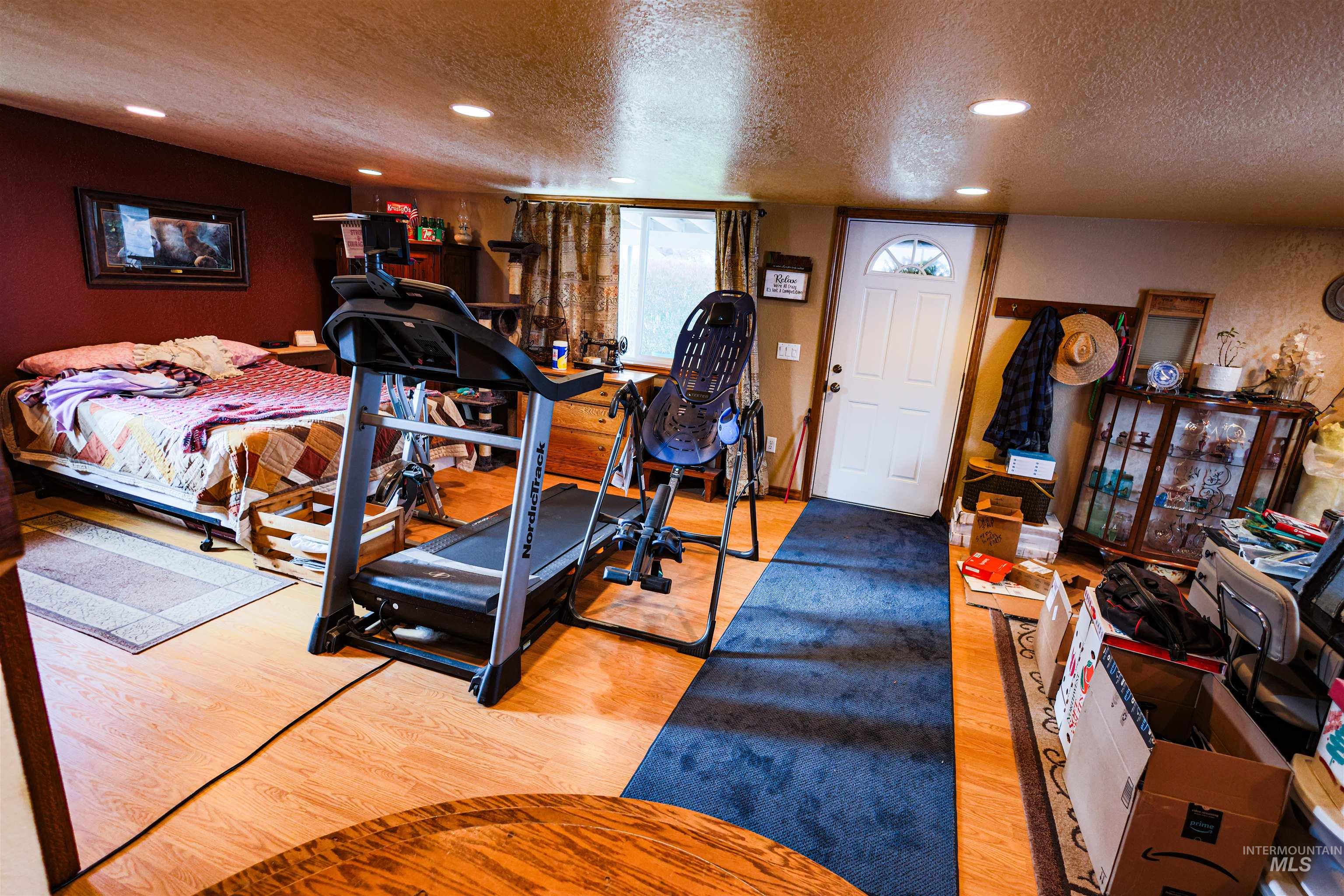 804 Maple Street Kamiah, ID 83536 - Photo 10 of 50 Bedroom with recessed lighting, a textured ceiling, and light wood finished floors