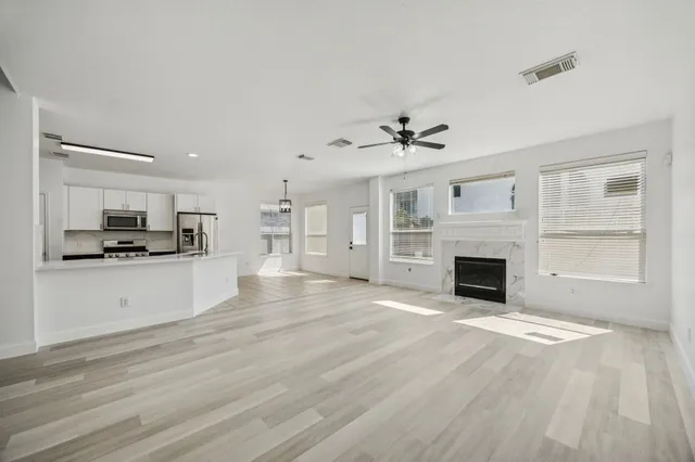 a view of kitchen with sink microwave and cabinets