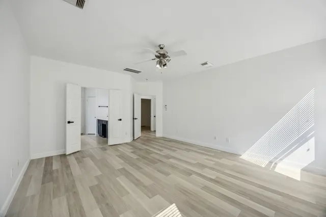 wooden floor in an empty room with a window