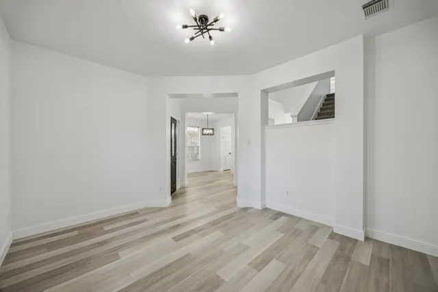a view of a livingroom with wooden floor and ceiling fan