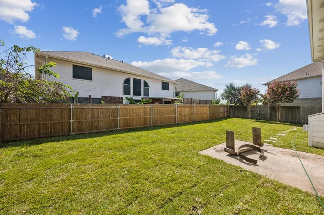 a view of a backyard with a garden and entertaining space