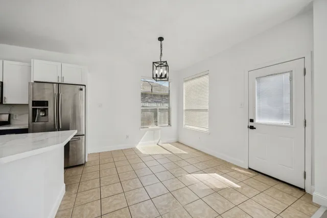 a view of a kitchen with a sink dishwasher and a refrigerator