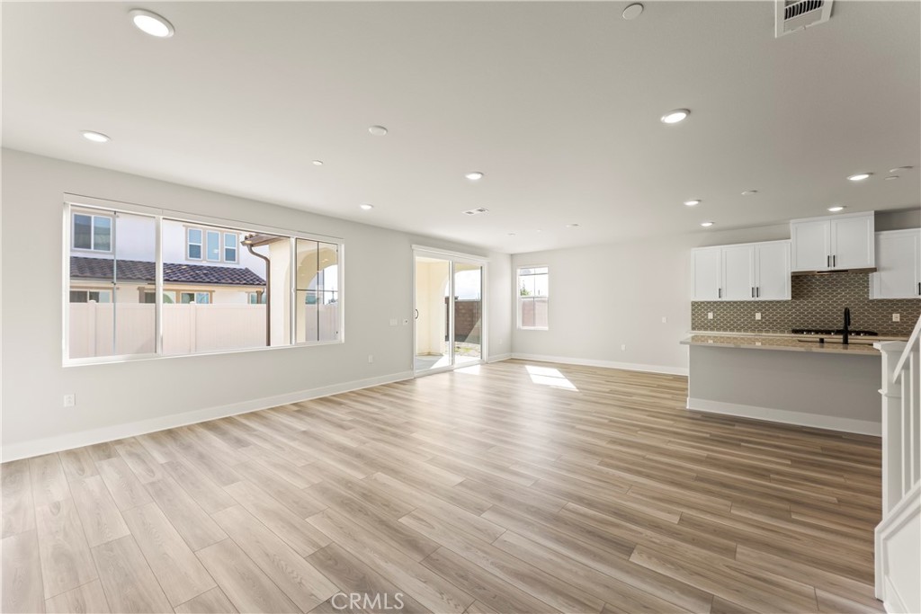 16717 Dara Avenue Chino, CA 91708 - Photo 11 of 41 a view of an empty room with window and wooden floor