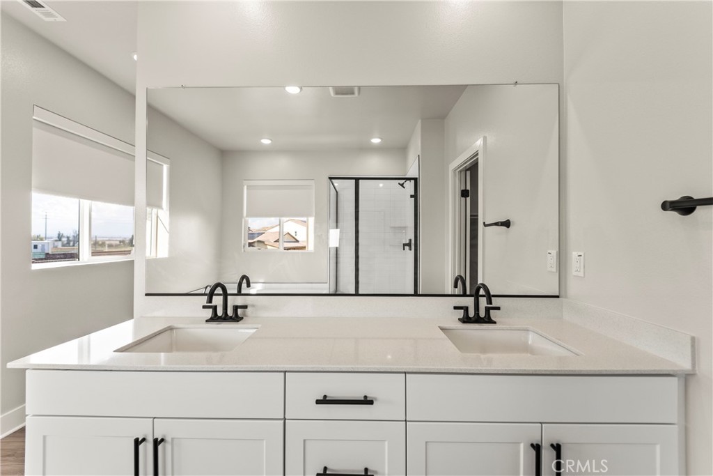 16717 Dara Avenue Chino, CA 91708 - Photo 32 of 41 a bathroom with a sink and a mirror