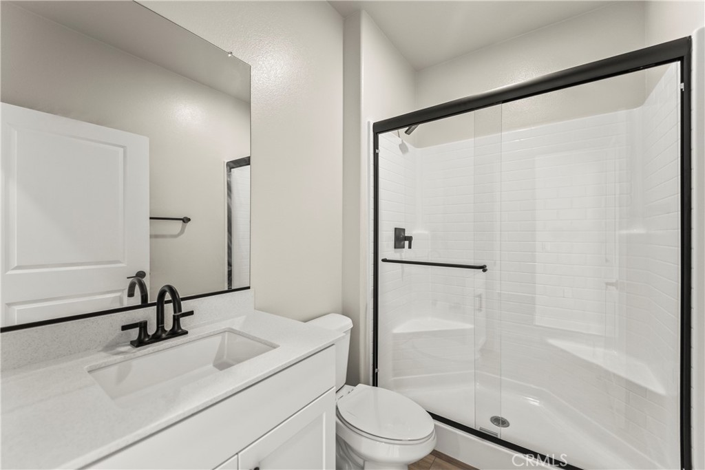 16717 Dara Avenue Chino, CA 91708 - Photo 7 of 41 a bathroom with a sink a toilet and a mirror