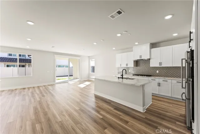 a kitchen with stainless steel appliances granite countertop a sink and cabinets