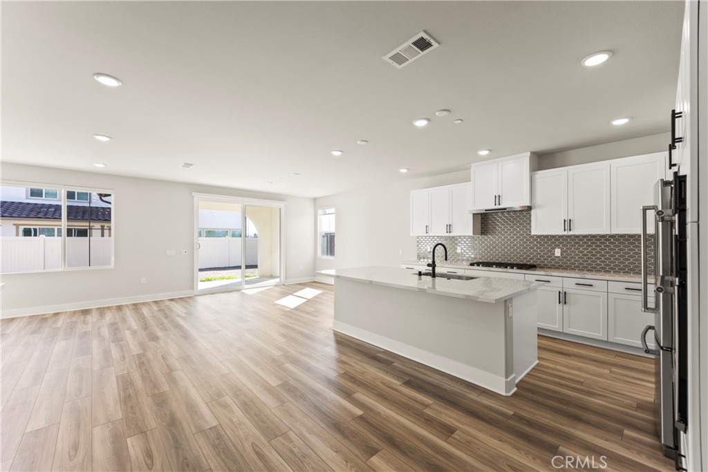 16717 Dara Avenue Chino, CA 91708 - Photo 10 of 41 a kitchen with stainless steel appliances granite countertop a sink and cabinets