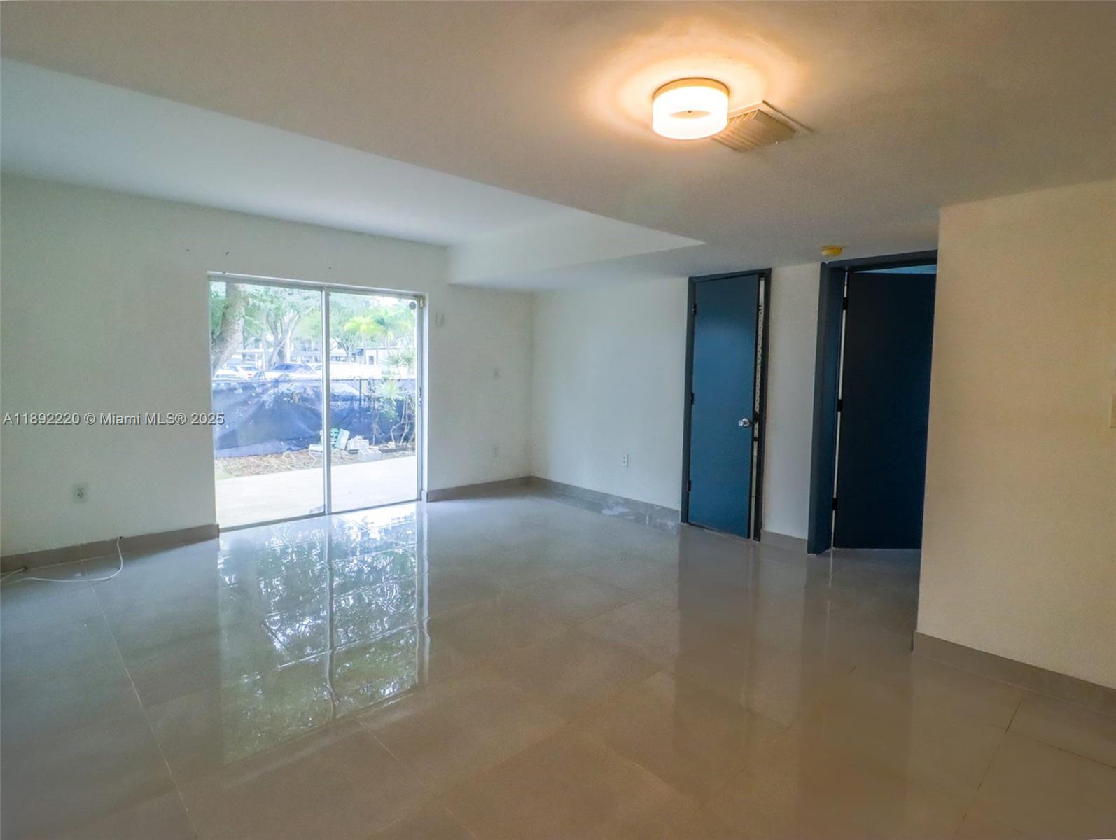 14010 Northeast 3rd Court, Unit 1 Miami, FL 33161 - Photo 16 of 26 an empty room with windows
