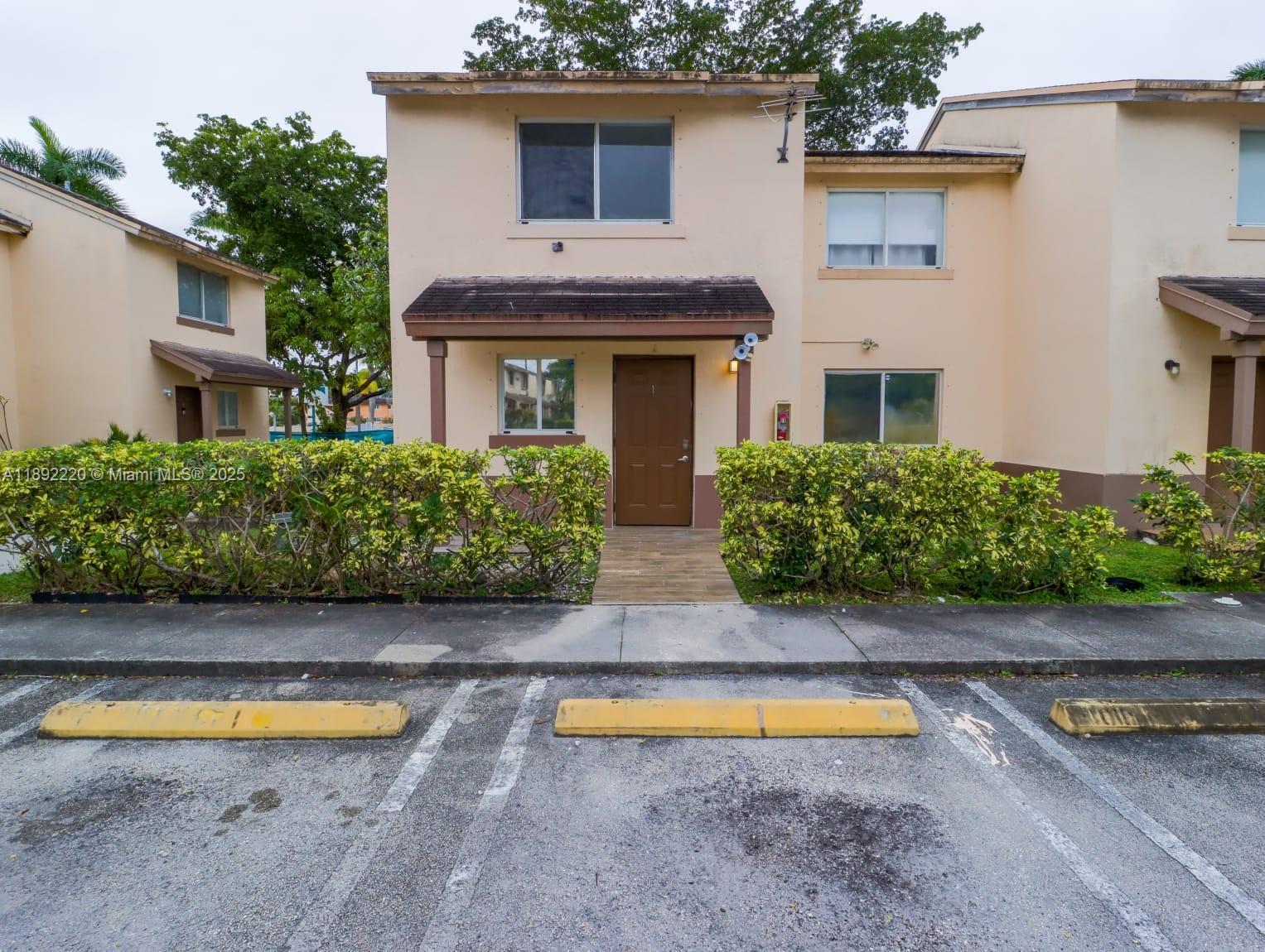 14010 Northeast 3rd Court, Unit 1 Miami, FL 33161 - Photo 19 of 26 a view of a house with backyard and swimming pool