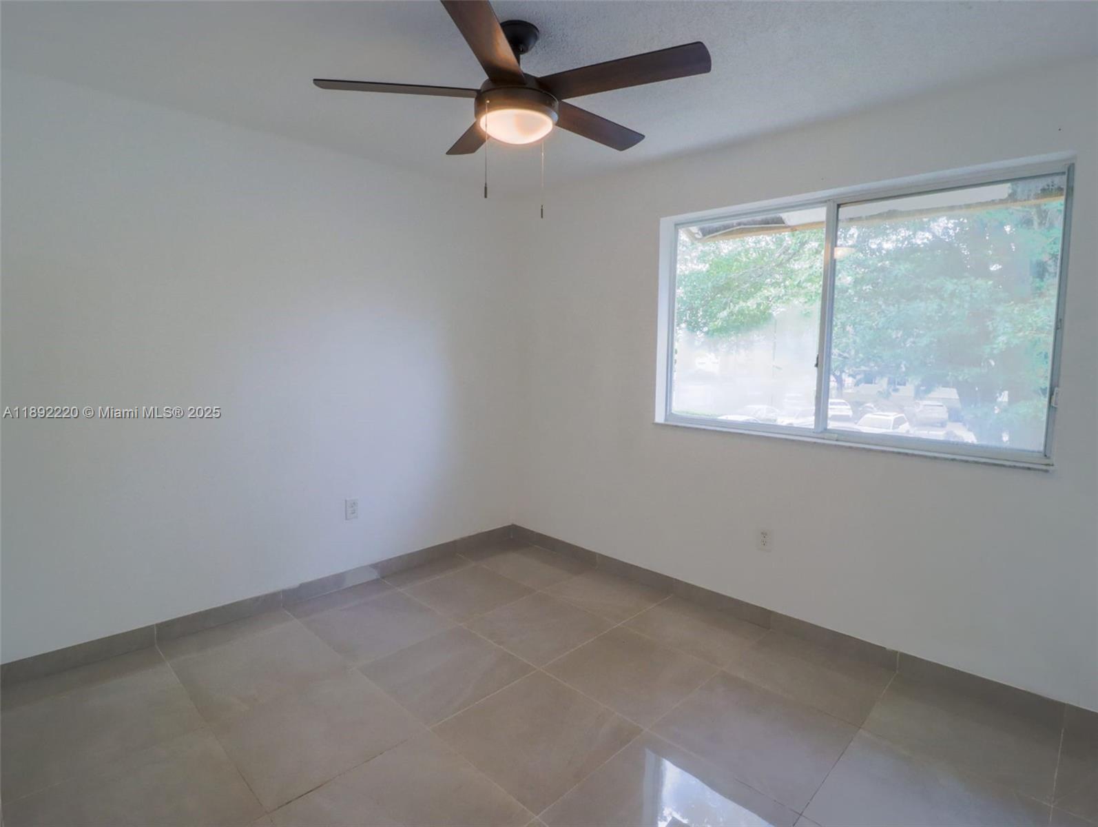 14010 Northeast 3rd Court, Unit 1 Miami, FL 33161 - Photo 23 of 26 an empty room with a window