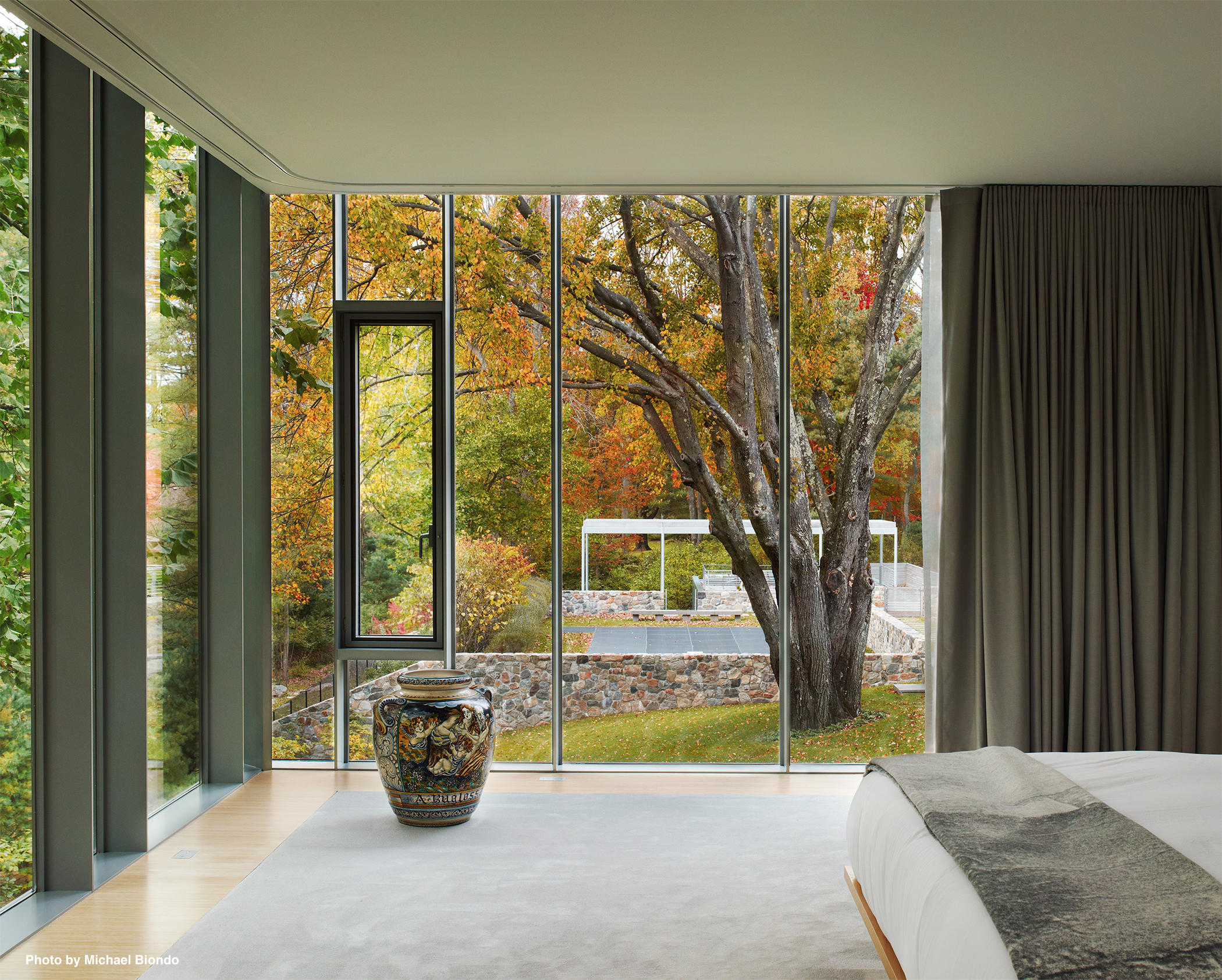 628 West Road New Canaan, CT 06840 - Photo 13 of 28 a spacious bedroom with a large bed and large windows