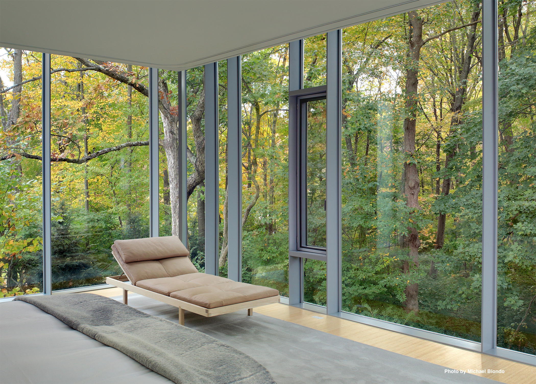 628 West Road New Canaan, CT 06840 - Photo 14 of 28 a living room with furniture and a floor to ceiling window
