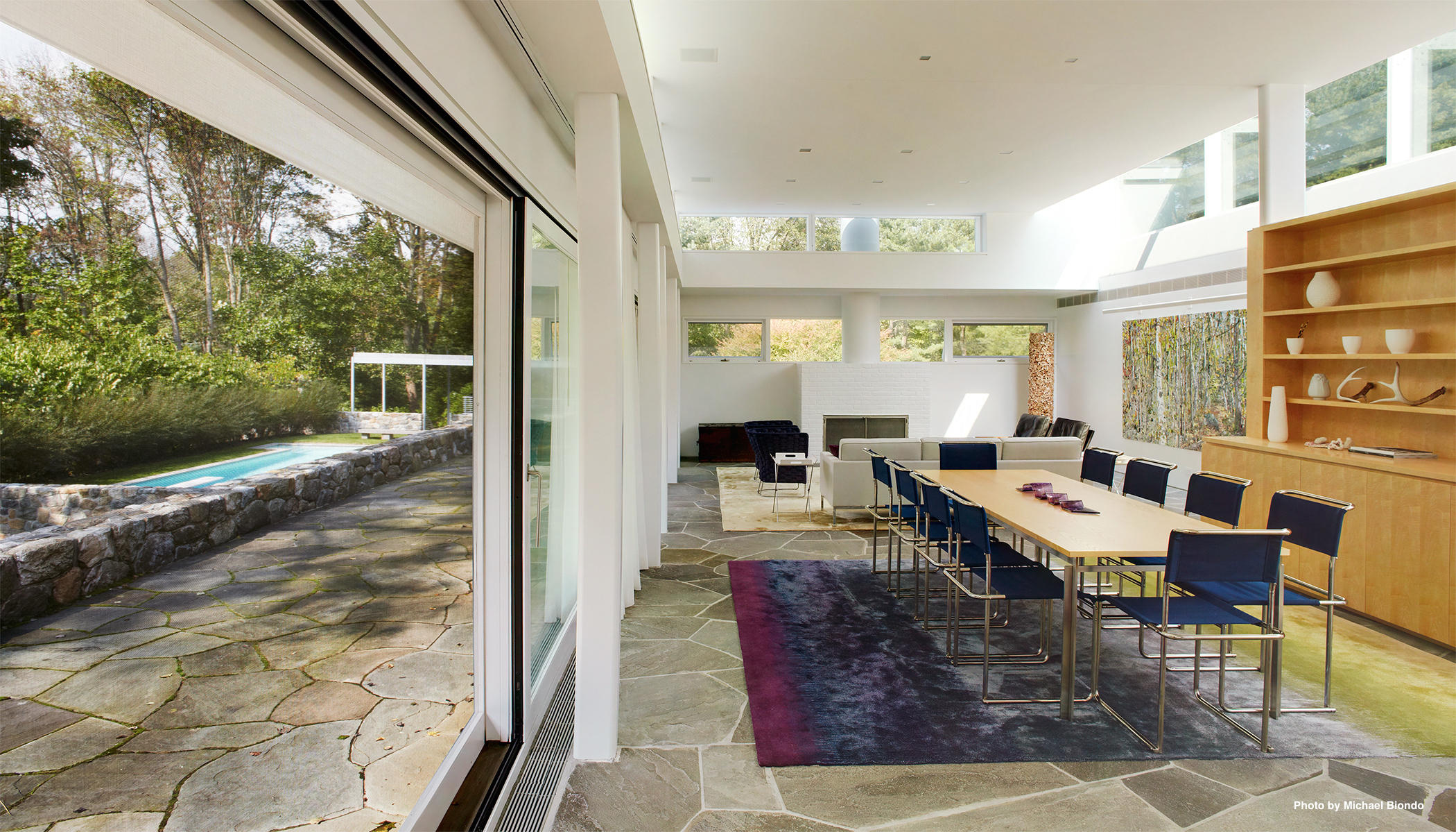 628 West Road New Canaan, CT 06840 - Photo 6 of 28 a living room with patio furniture and a floor to ceiling window