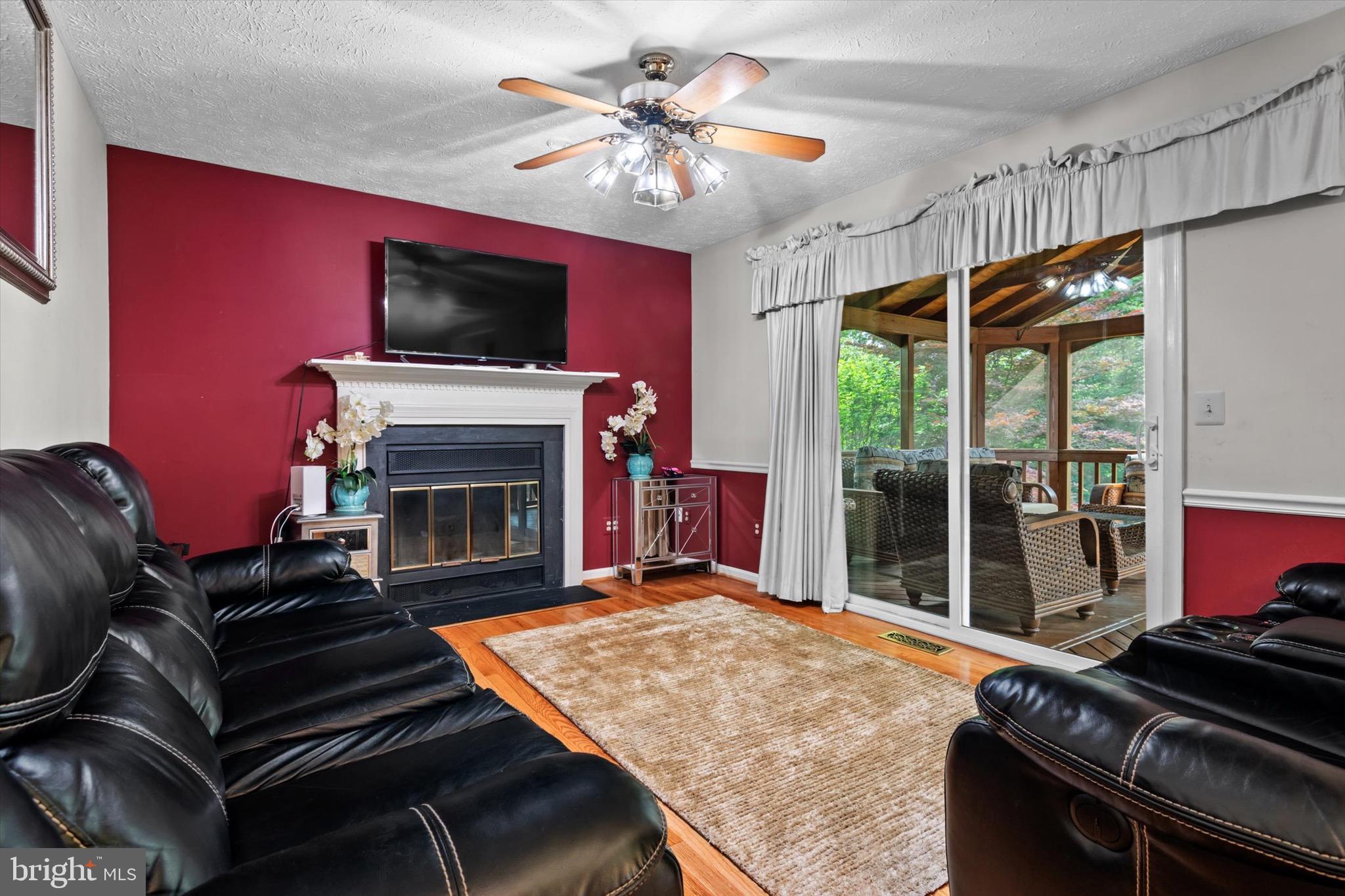 10462 Brackets Ford Circle Manassas, VA 20110 - Photo 11 of 39 a bedroom with furniture fireplace and flat screen tv