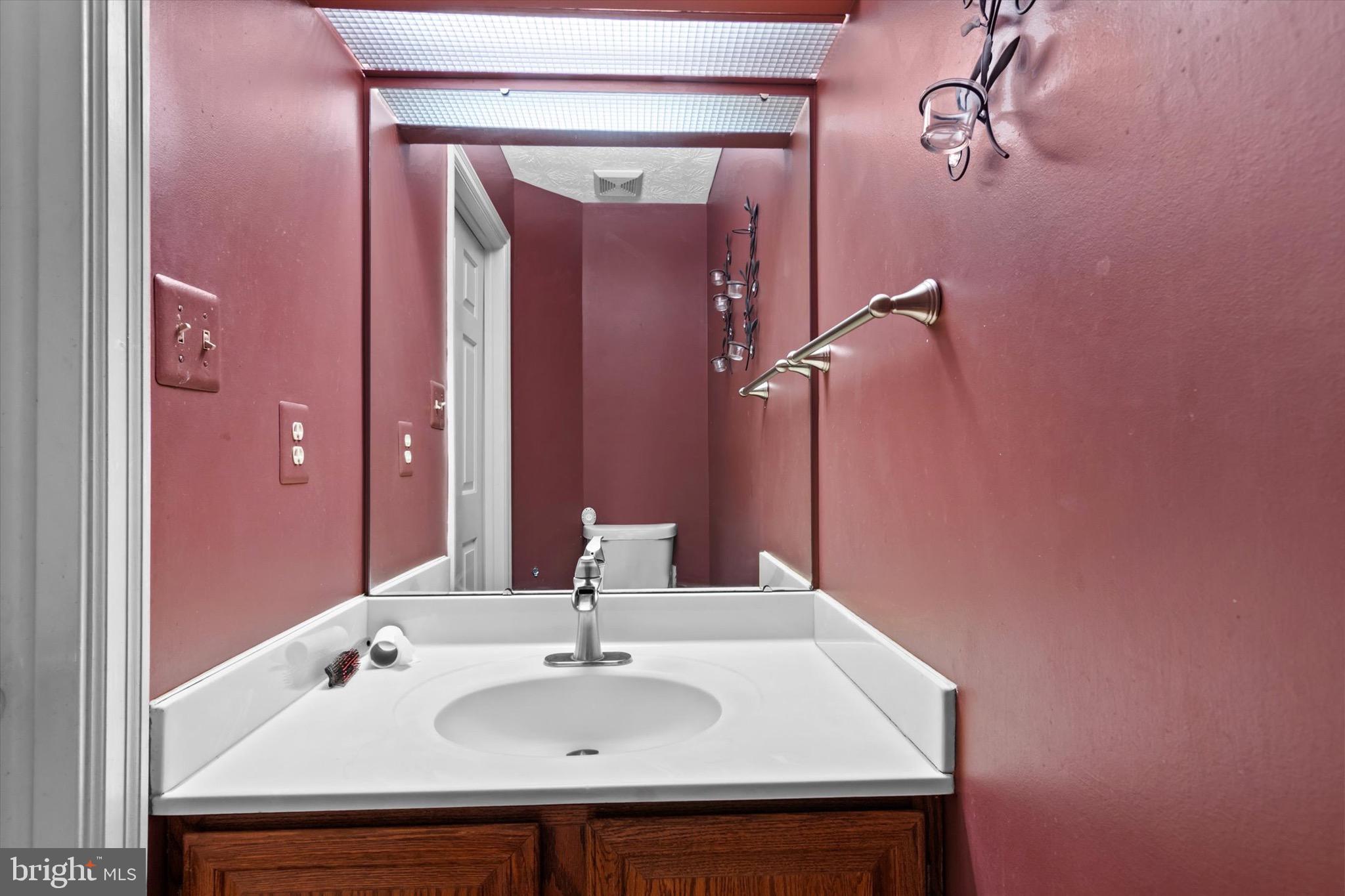 10462 Brackets Ford Circle Manassas, VA 20110 - Photo 13 of 39 a bathroom with a sink and a mirror